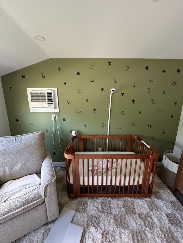 Nursery with assembled crib, dresser and glider