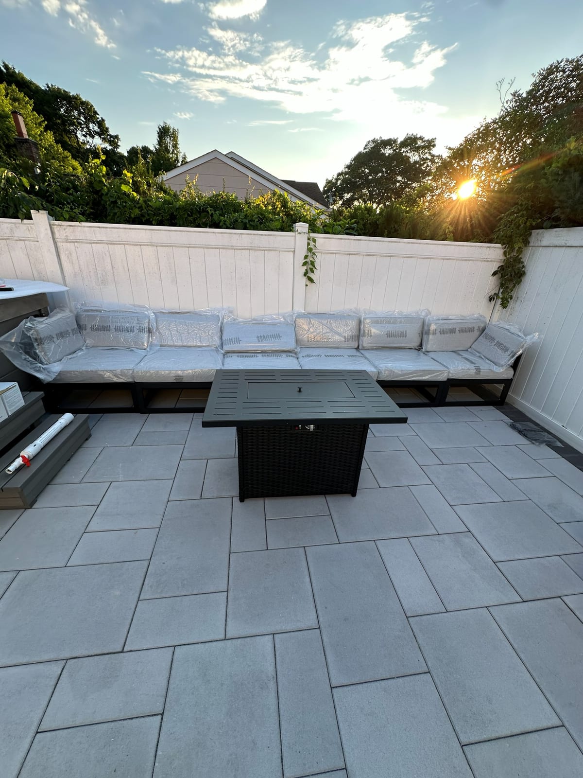 Composite deck with sectional seating and fire table at dusk