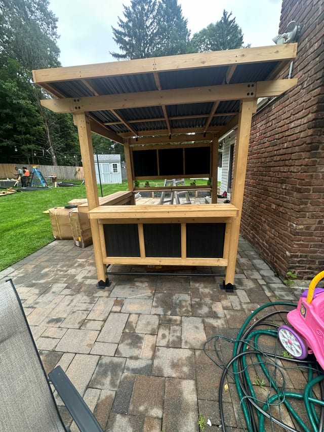 Cedar pergola and outdoor bar built in a back garden