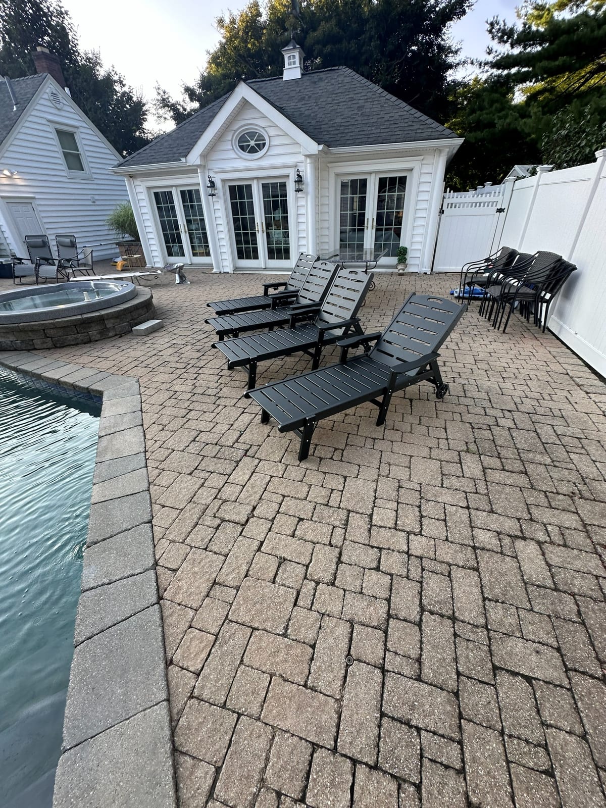 Paver patio with dining set at a large residential property