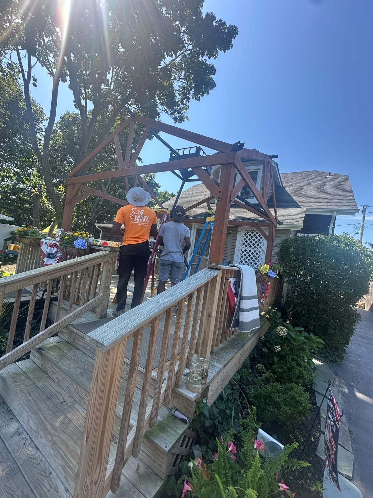 Handy Hippo crew in branded shirts building a pergola